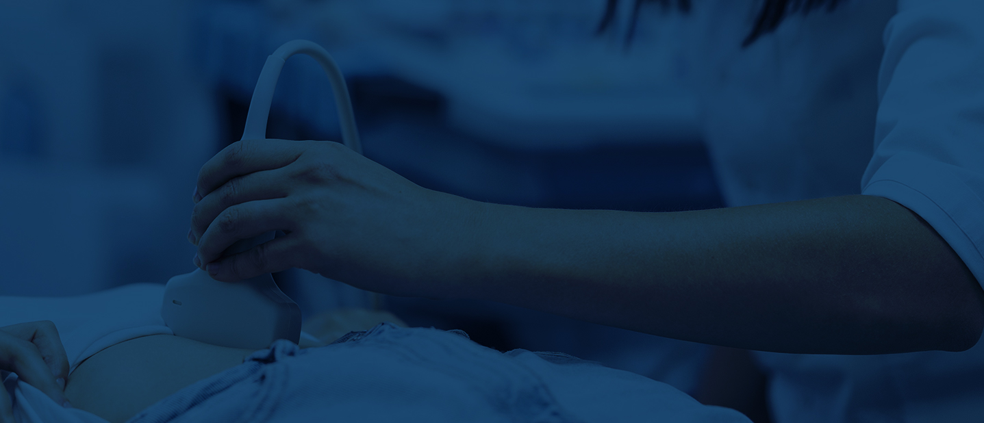A clinician performing an abdominal ultrasound scan